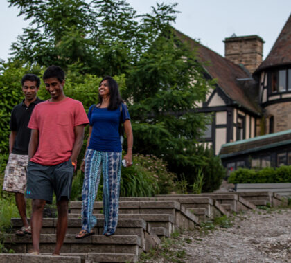 A family walks along a path at Punderson