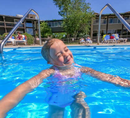 a girls swims at the outdoor pool at salt fork