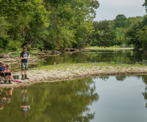 a father son fishes at hueston woods