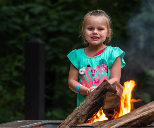 a girl enjoys a bonfire at shawnee