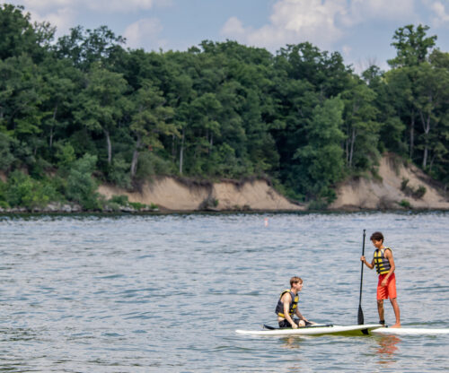 kids paddleboarding on lake at deer creek