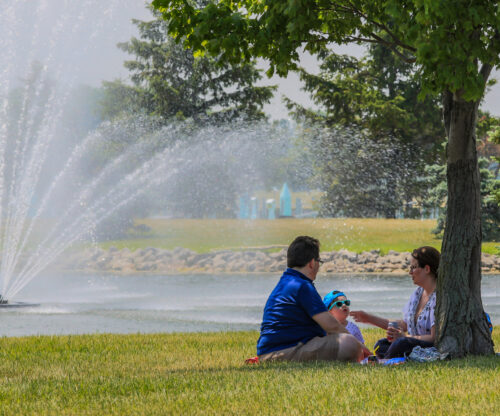 a couple enjoys a picnic with a view of the water feature in the bay at maumee bay