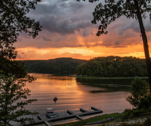 The sun sets over the lake at Burr Oak lodge