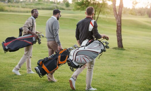 People carrying golf bags