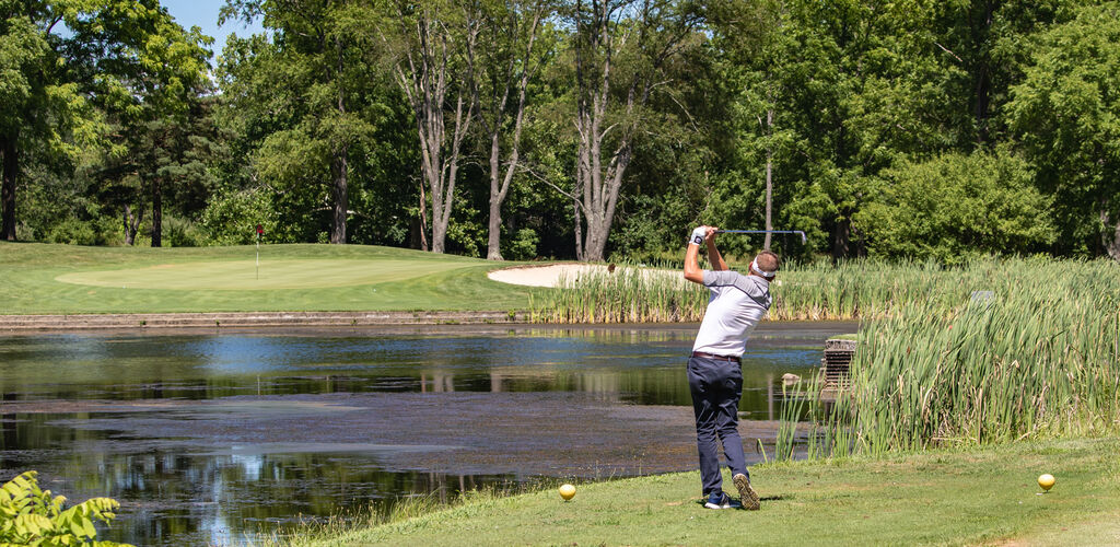 Man golfing at Hueston Woods Lodge