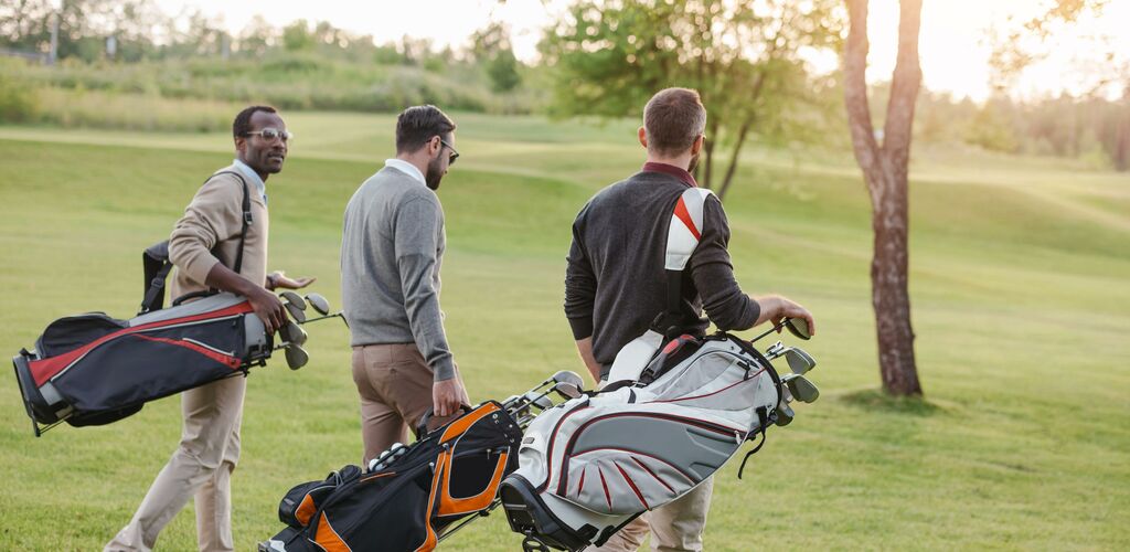 People carrying golf bags